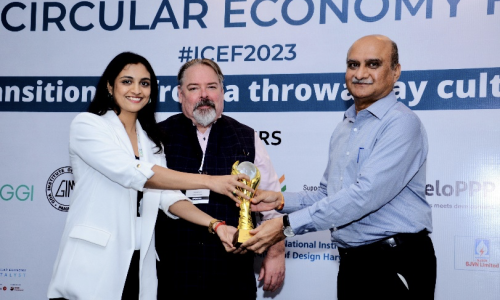 Recognition Ceremony at ICEF 2023 – Circular Economy Forum Award ceremony at ICEF 2023 where a woman receives a trophy from two dignitaries during a circular economy event.